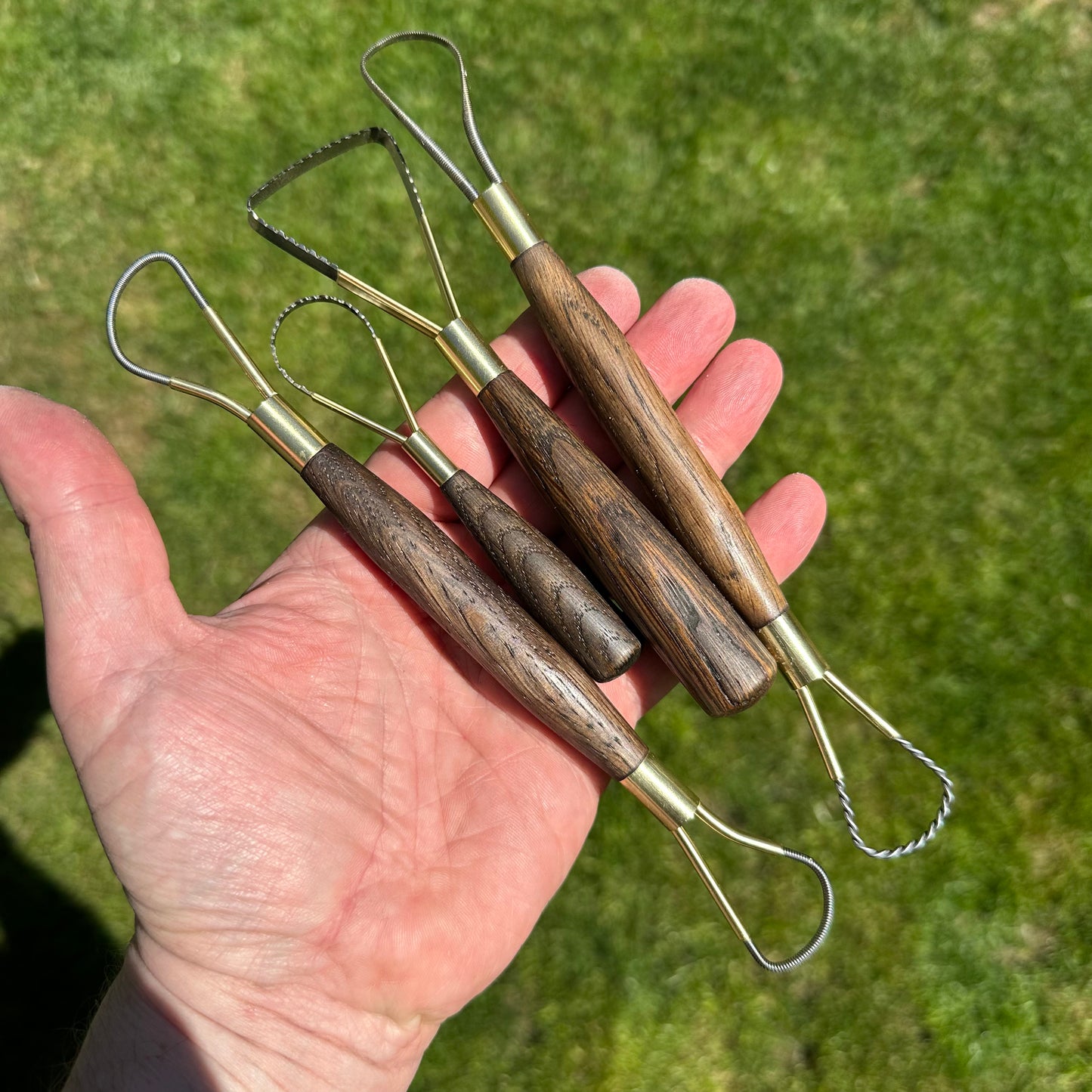 Set of 4 ebonised antique oak rake tools